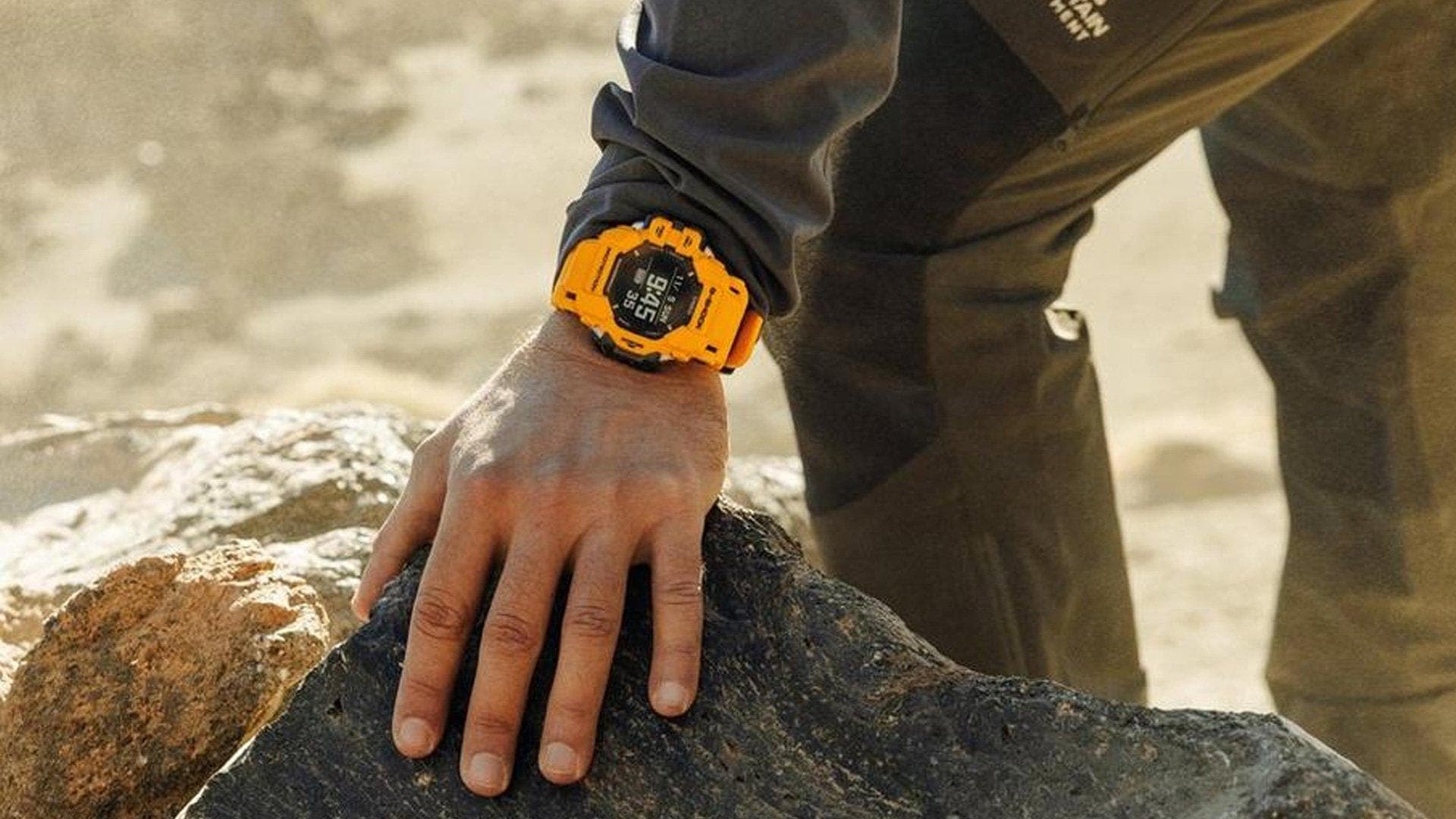 Person wearing a G-Shock watch on a beach